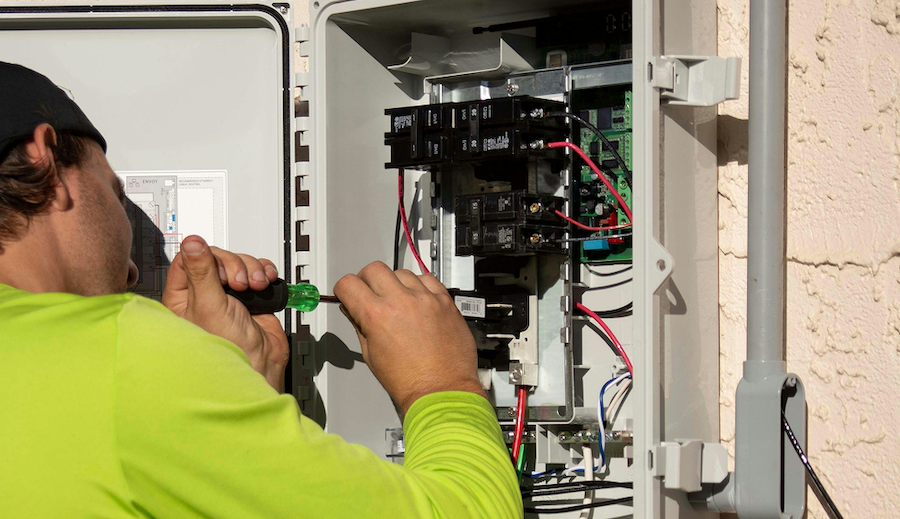 Elektriker installiert Kabel und Anschlüsse an der Wand